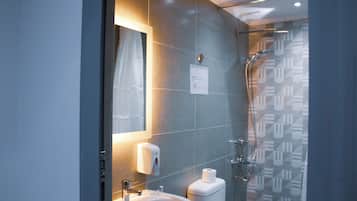 Separate tub and shower, towels, soap, toilet paper