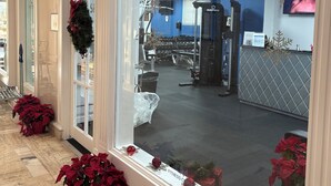 A fitness center with exercise equipment, a reception desk, and Christmas decorations. - Tortuga festival special 1Bedroom  Suite,CityView Ft Lauderdale&Two QueenBeds (Fort Lauderdale)