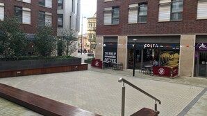 A plaza with a coffee shop named 'The Home of Irresistible Coffee' and a 'Costa' sign. - For Students Only Hope St near Liverpool Central Station (Liverpool)