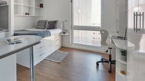 A modern, well-lit bedroom with a bed, bedside table, and a large window. - For Students Only Hope St near Liverpool Central Station (Liverpool)