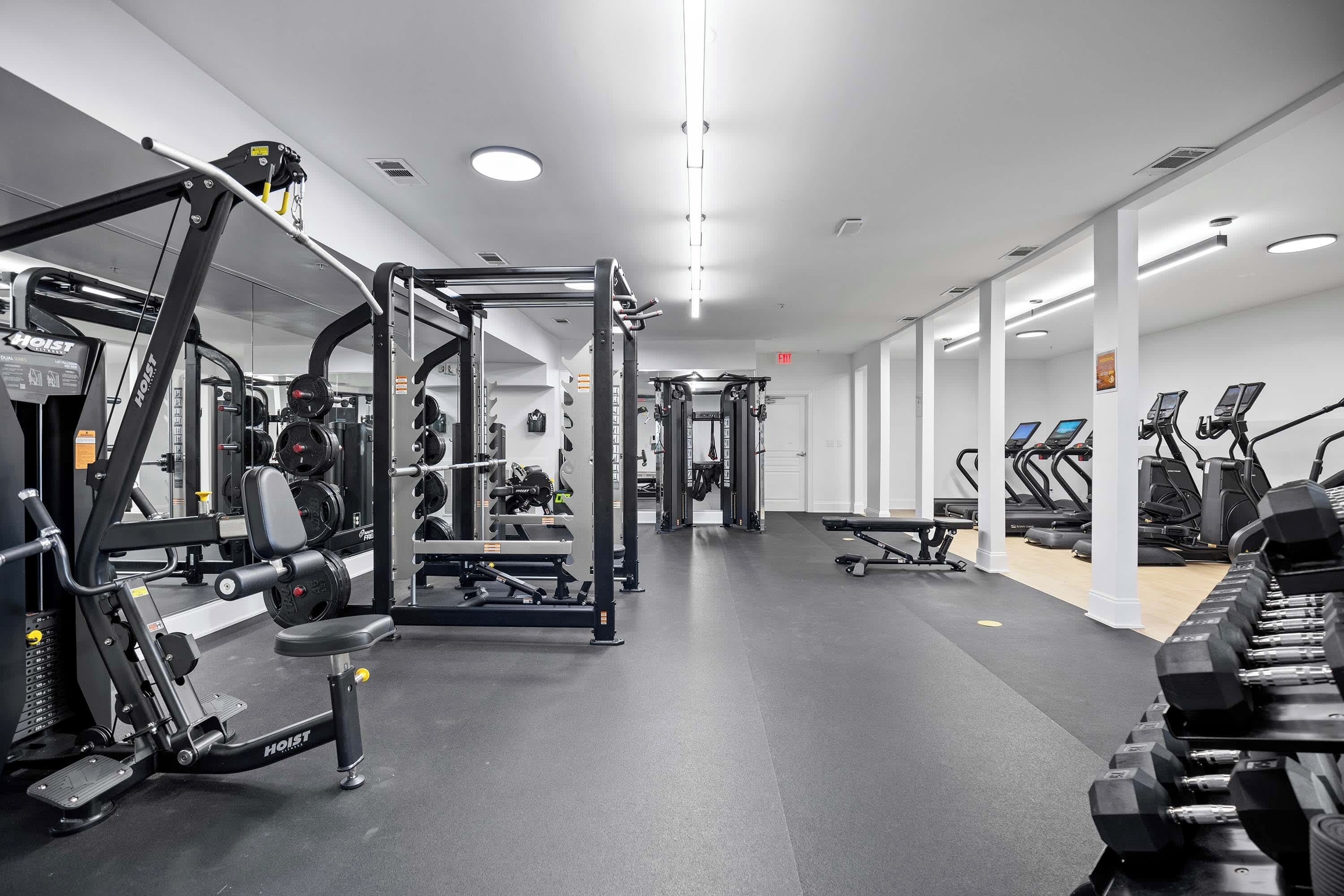 A gym with various exercise equipment, including weight machines and treadmills.