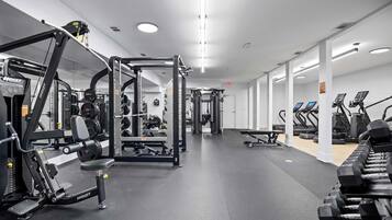 A gym with various exercise equipment, including weight machines and treadmills.