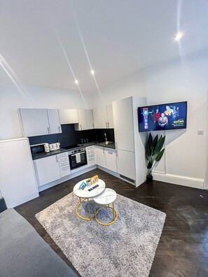 Enjoy a comfortable stay in this well-appointed living space with a sleek kitchen area and flat-screen TV.