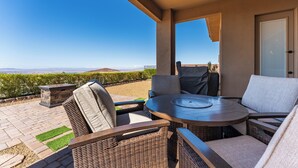 An outdoor patio with wicker furniture, a round table, and a view of the landscape. - Mountain Top Oasis with lake views  - WiFi included (Lake Havasu City)