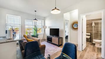 Superior Apartment | Living area | 70-inch Smart TV with digital channels