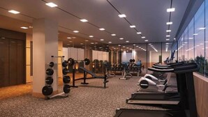 A modern gym with various exercise equipment, including treadmills and weight machines.