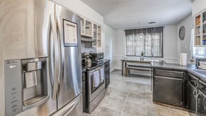 A modern kitchen with stainless steel appliances, a built-in oven, and a water dispenser. - Near Parks Tranquil Fox Trails (Memphis)