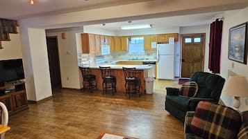 A compact living space with a kitchen, dining area, and a sofa.
