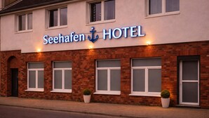 A hotel named 'Seehafens HOTEL' with a brick facade, multiple windows, and potted plants on the ground floor. - Hotel am Seehafen (Hamburg)