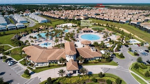 A resort with multiple buildings, a central pool, and a short 8-minute walk to the facilities from the home location.