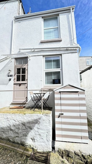 A two-story house with a front door, a small porch, and a shed. - Award Winning "Smugglers Hide" 2 Bed Harbour House (St Ives, Saint Ives)