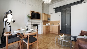 A modern kitchen with wooden cabinets, a built-in oven, and a microwave. - Bonnie Hotel - Smart Boutique ApartHotel - Haymarket Edinburgh (Edinburgh)