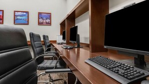 A conference room with a long table, four black leather chairs, and three computer monitors. - Discover Family Fun and Luxury at The Westin Desert Willow Villas – 1 Bd Premium (Palm Desert)