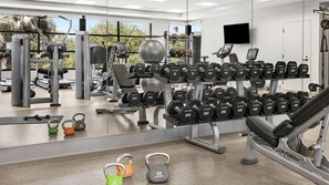A gym with various weightlifting equipment, including dumbbells and kettlebells, arranged on racks and the floor. - Discover Family Fun and Luxury at The Westin Desert Willow Villas – 1 Bd Premium (Palm Desert)