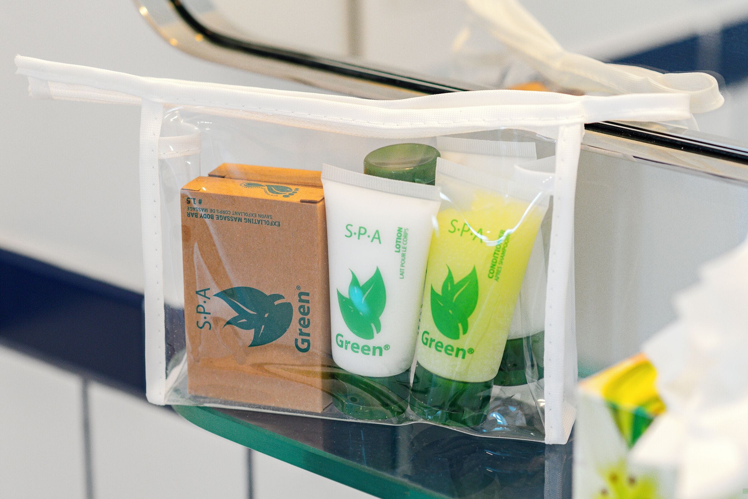 A plastic bag containing spa products on a glass shelf.