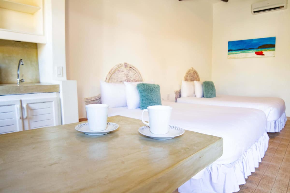 Standard Quadruple Room, Pool View | Minibar, in-room safe, desk, laptop workspace