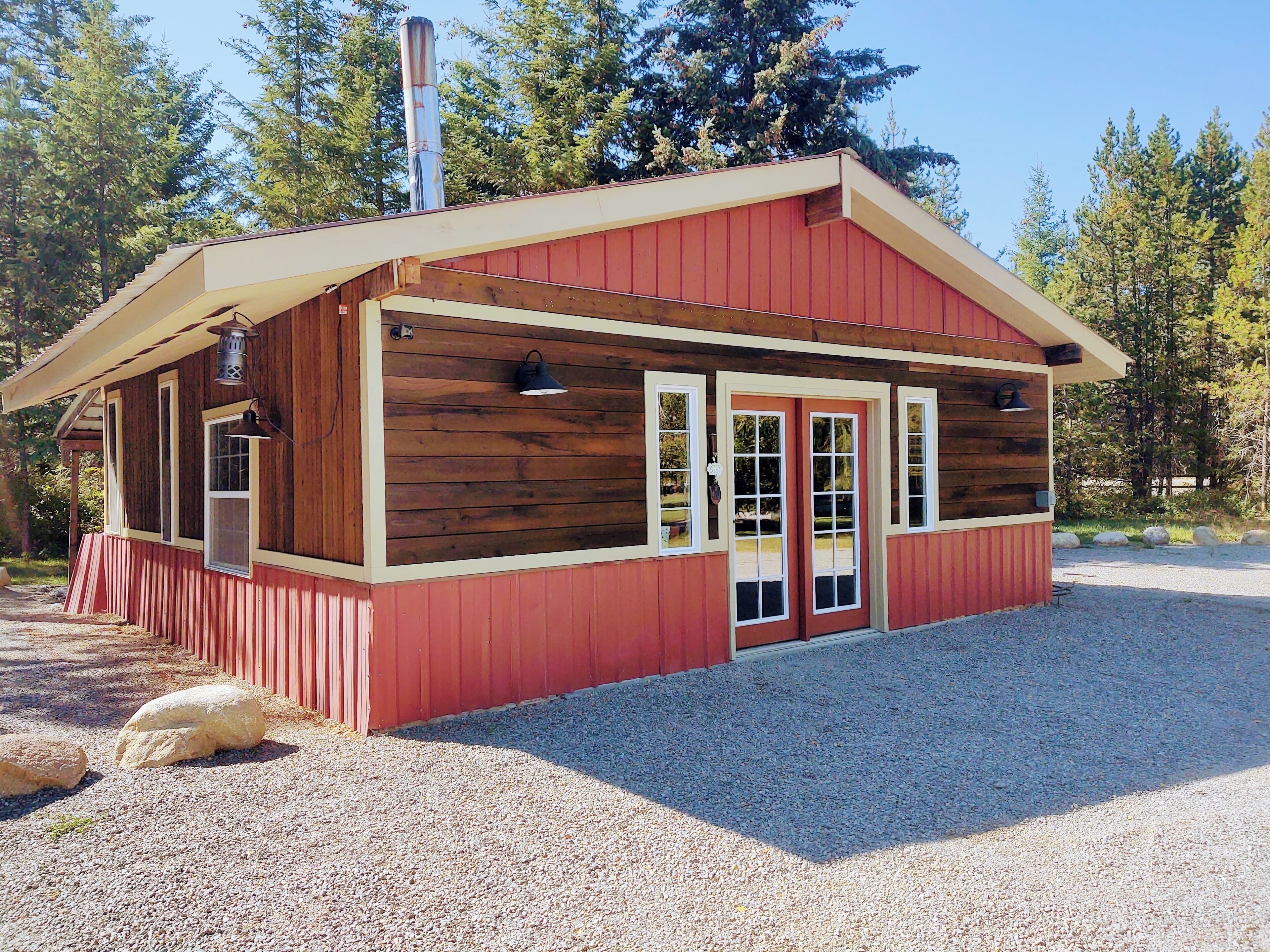 A small, single-story wooden building with a red exterior and a sloped roof.