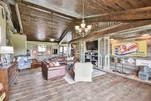 A rustic interior with a wooden ceiling, a dining area, and a kitchen. - Lazy River Retreat in northwest Houston (Cypress)