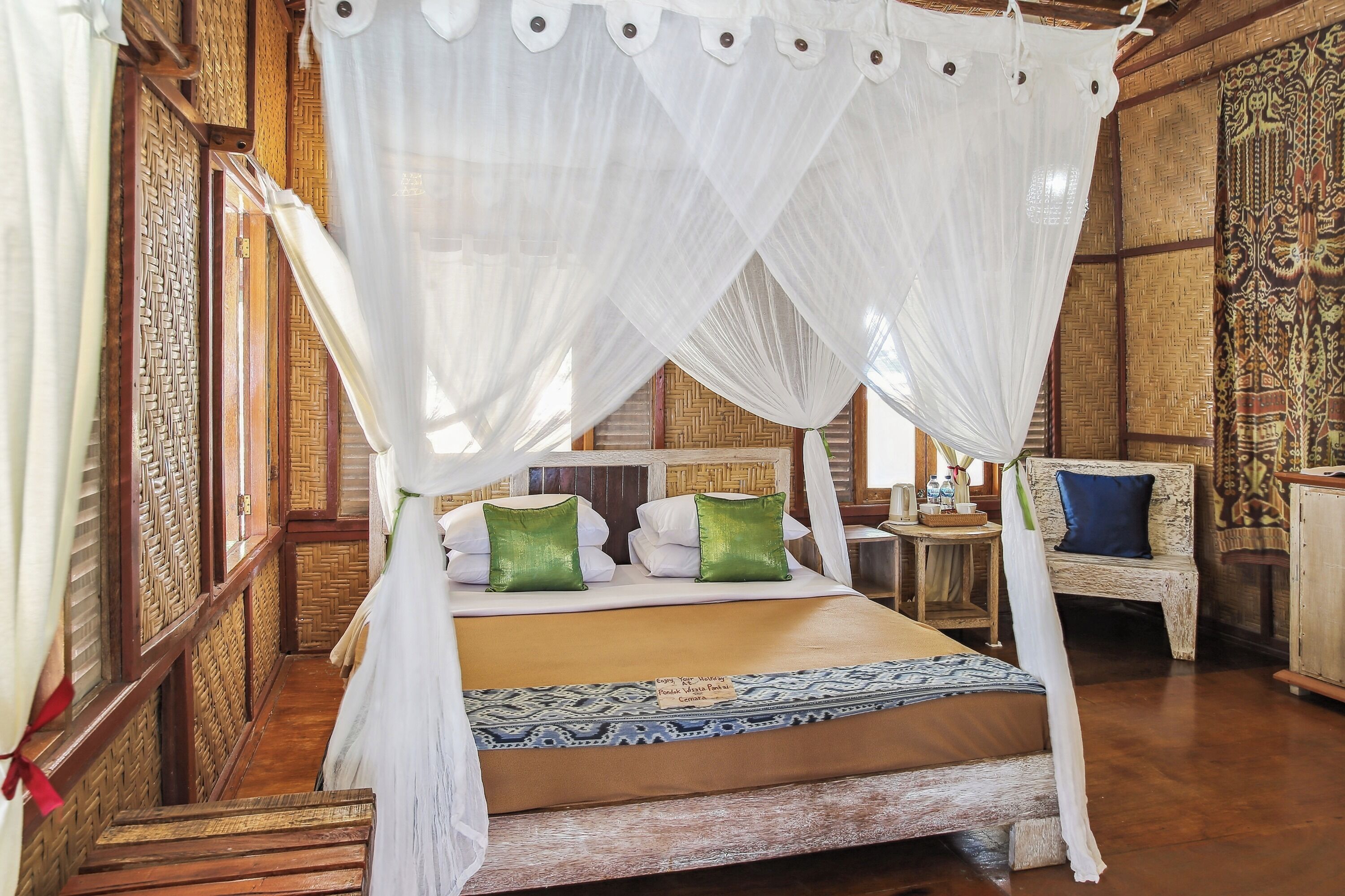 A traditional room with a bed, a bench, and a small table.
