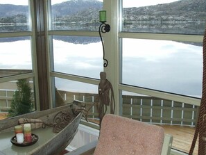 Enjoy breathtaking views of the surrounding mountains and water from this room's large window.