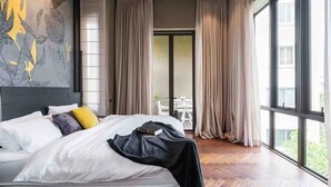 A hotel room with a large bed, a view of the outdoors, and a modern design. - The Oasis Tranquil Escape (Bangkok)