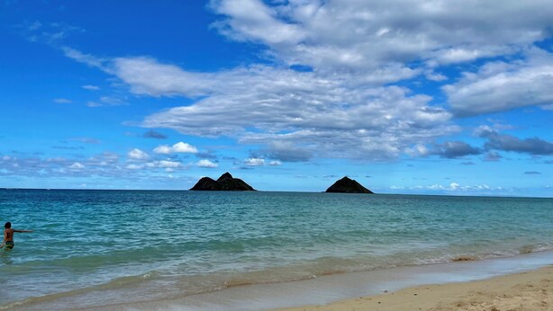 Una spiaggia con cielo sereno e acque calme.