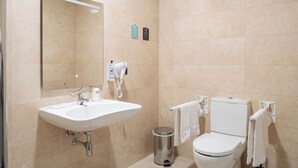 A modern bathroom with a sink, mirror, toilet, and towel rack. - Alda Malvasia (Haro)