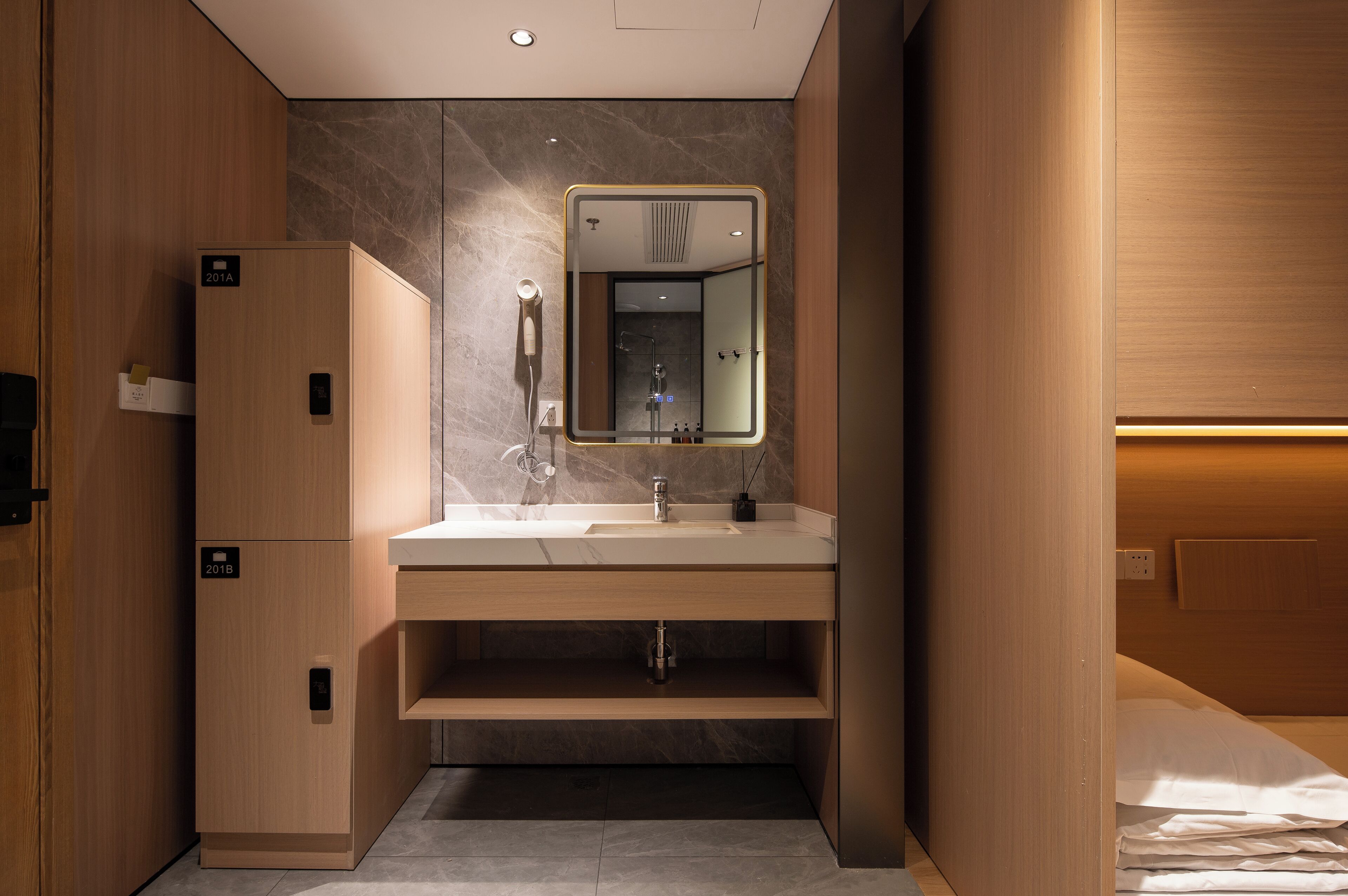 A modern bathroom with a vanity, mirror, and shower.