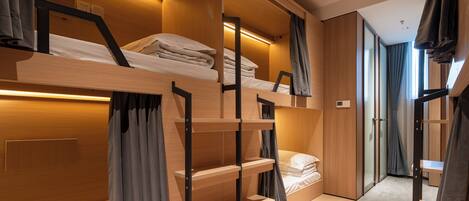 A modern, multi-level bunk bed room with built-in shelves and a cozy, warm ambiance.