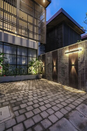 A modern building with a stone facade and a sign that reads "Villa Aashiya". - Villa Aashiyana (Canggu)