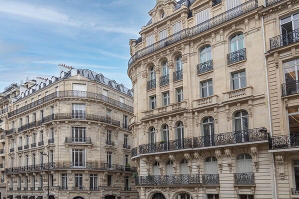 A historic building with ornate balconies and classical architecture.