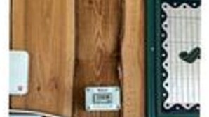 A wooden wall with a white electrical outlet and a framed picture. - 4 Star Holiday Home in Tarm (Tarm)