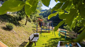 A playground with a slide, swings, and a climbing structure.