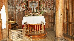A wooden interior with a wooden altar, a white cloth-covered table, and a woven chair. - 6 Person Holiday Home in Ovre Ardal (Ardal)