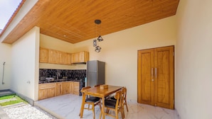 Une cuisine moderne avec des meubles en bois, un plan de travail en marbre et un réfrigérateur encastré.