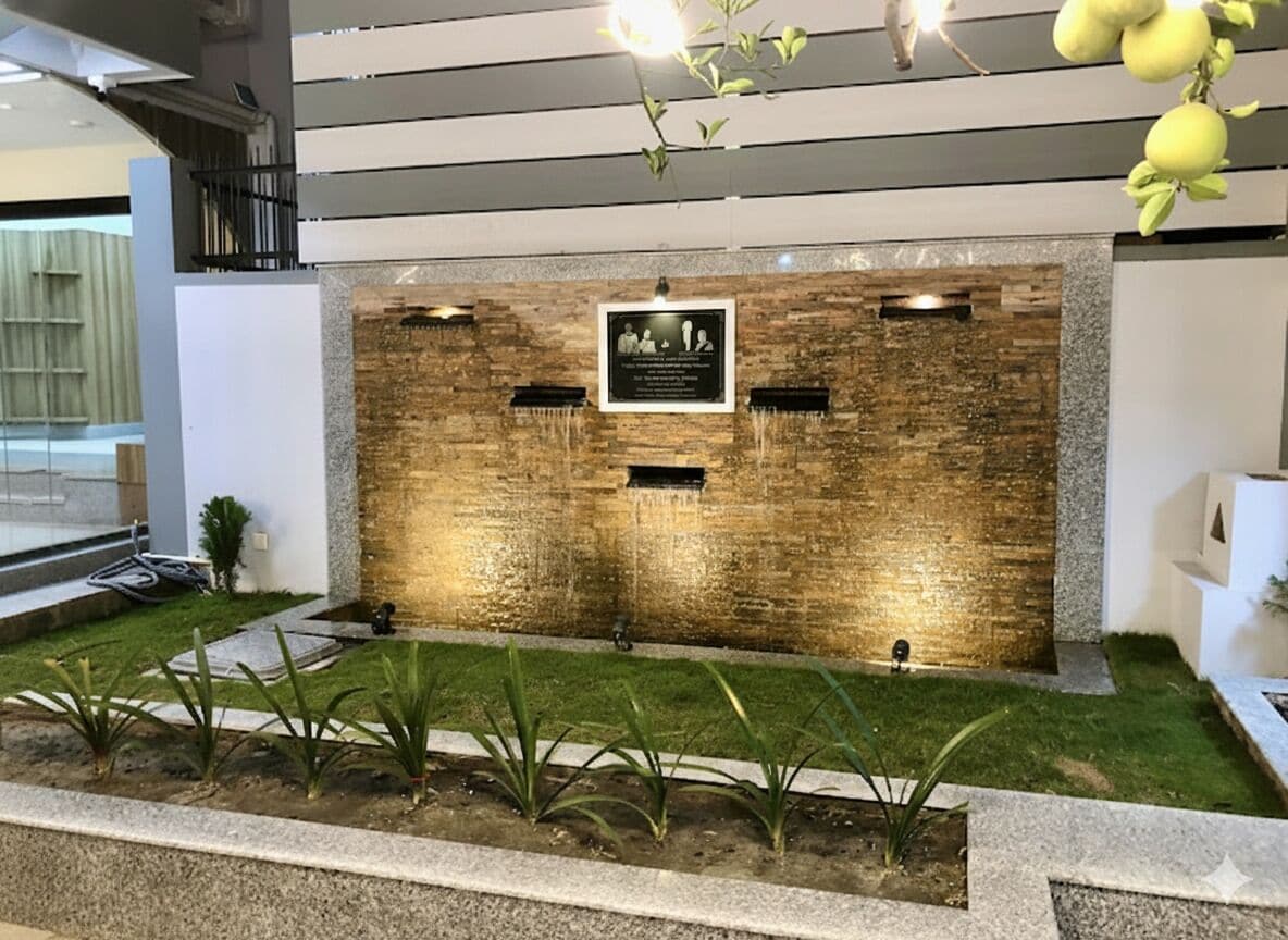 A reception area with a wooden wall, a plaque, and a water feature.