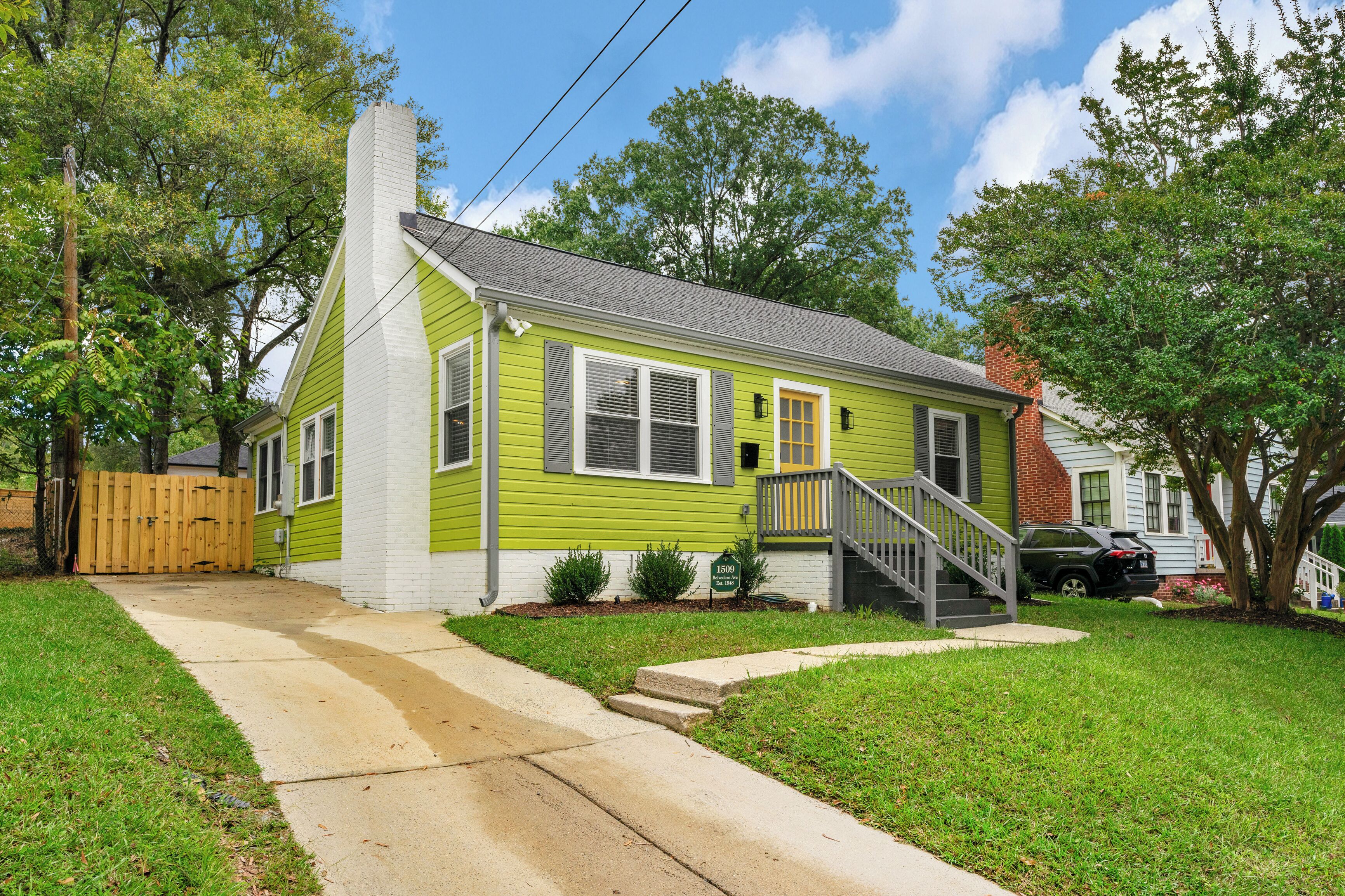 A single-story house with a front porch, a visible number plate, and a driveway leading to the front door.