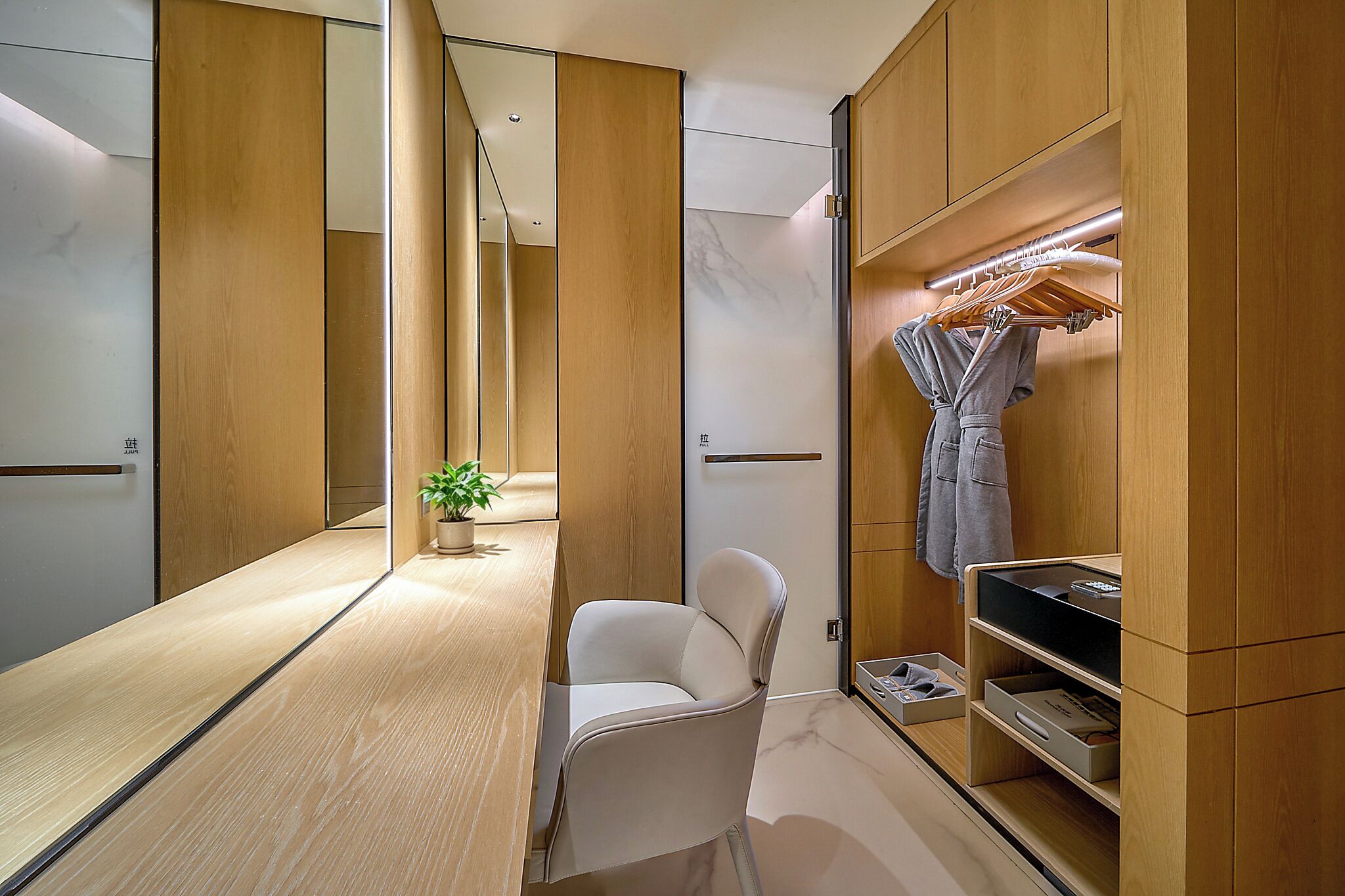 A modern bathroom with a vanity, mirror, and a shower area.