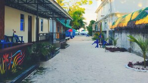 A narrow street with buildings on either side, a covered walkway, and a clear sky. - Chef Panyang Beach Resort 2 Okoy (Santa Fe)