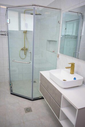 Family Apartment, Balcony, City View | Bathroom | Shower, free toiletries, slippers, towels - Lux Suites Royal Oaks Residency (Nairobi)