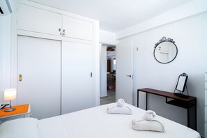 Relax in a stylish room with a large bed, bedside table, and wardrobe.