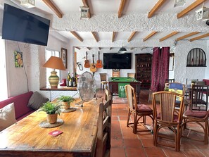 Relax in this inviting space with a dining table, comfortable sofa, and billiards table.