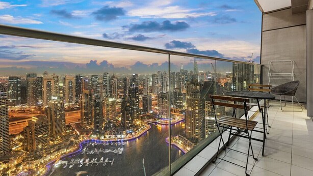 A high-rise apartment with a panoramic view of a cityscape at dusk. - FIRST CLASS | 1BR | Amazing Marina Views (Marina)