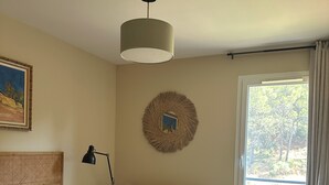 A bedroom with a bed, a round mirror, a desk, and a window with curtains. - Top floor luxury apartment in a secure residence  (Châteauneuf-le-Rouge)