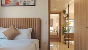 Una camera da letto con un letto, una testiera e un quadro appeso al muro.