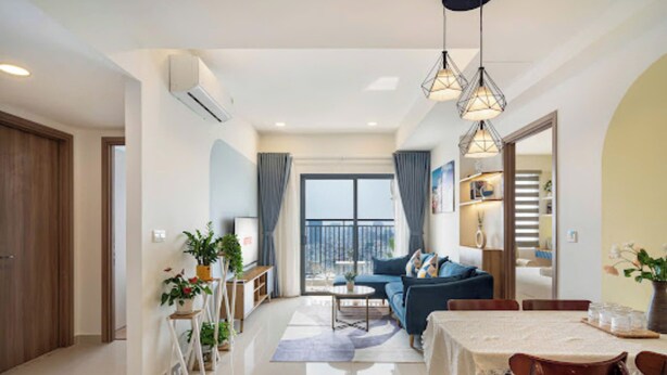 A modern living room with a sofa, dining table, and chairs. There is a balcony with a view, and the room has a large window. - Soho Residence-Tony Apartment (Ho Chi Minh City)