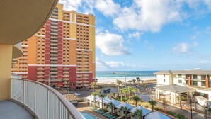 A hotel with a pool, beach view, and a pier in the distance. - Calypso Tower 3  507, 3 Bed,  2 Bath w Gulf Views! (Panama City Beach)