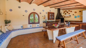 A kitchen with a large island, seating area, and decorative tiles. - Villa La Rosaleda - By Dream Villas Pollensa (Pollensa)