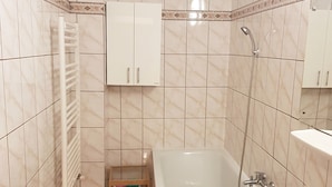 A bathroom with a bathtub, a sink, and a shower. - Central Apartment Bucharest - Vitan Mall (Bucuresti)