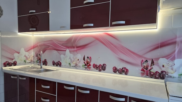 A modern kitchen with a stainless steel sink, a white countertop, and a backsplash with floral patterns. - Central Apartment Bucharest - Vitan Mall (Bucuresti)